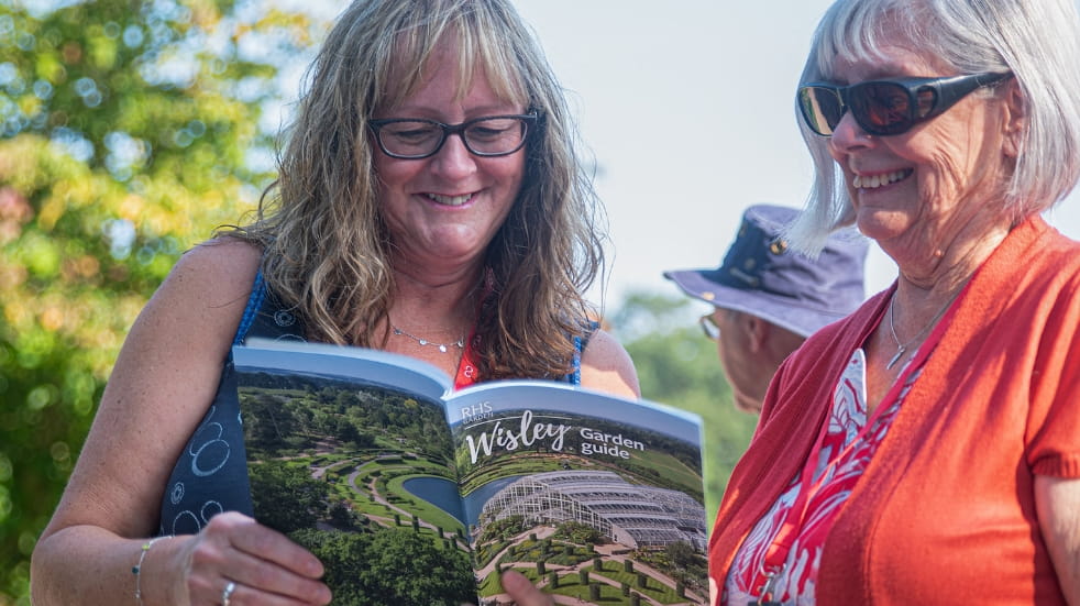 Boundless members reading a RHS Wisley guide